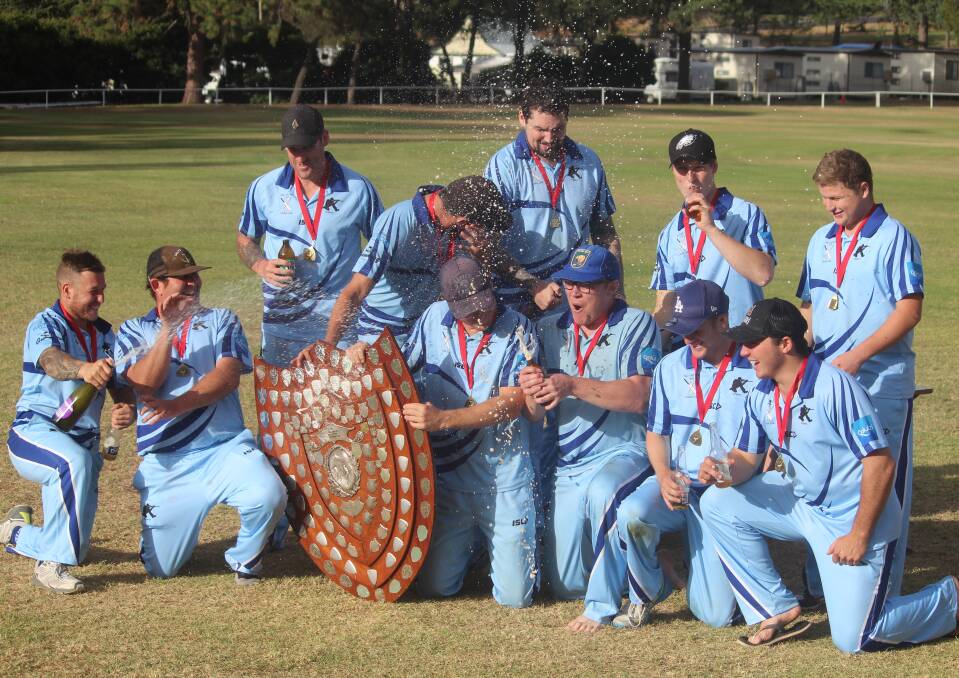 Winners: The Snipers quickly broke out the champagne to celebrate their victory over the Pirates in the A Grade grand final. Photo: Zac Lowe.