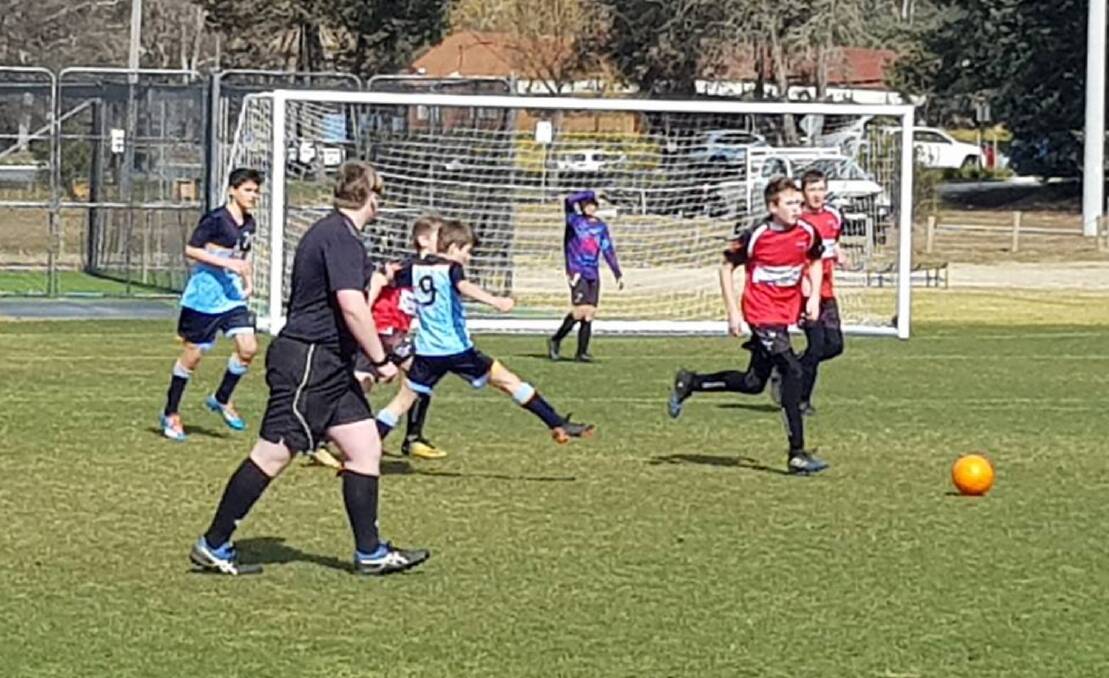 Run for it: The Yass Redbacks Under 13's in the midst of their match against Grammar, which finished with a 3-1 victory for the Yass side despite playing against very good opposition. Photo: Yass Redbacks. 