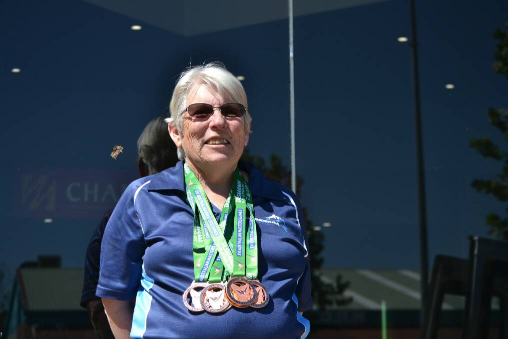 Weighed down: Joan Bratton with her six medals from the Australian Masters Games in Launceston from October 21-28. Photo: Zac Lowe
