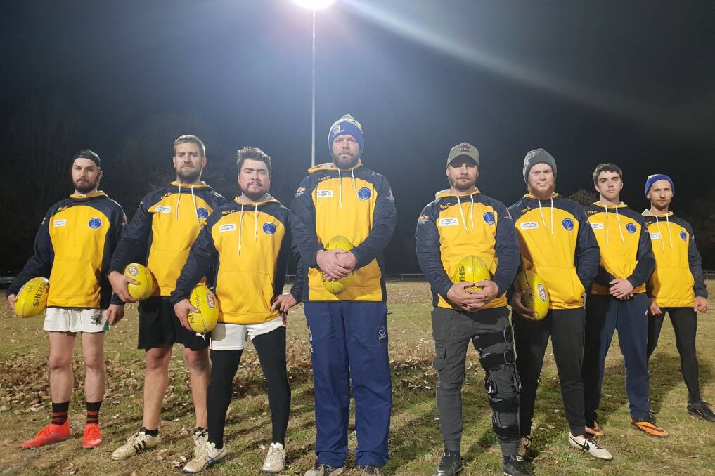 Benefits: The Murrumbateman Football Club, led by Andy Ingold (fourth from left) is already reaping the benefits of the light towers. Photo: Zac Lowe.