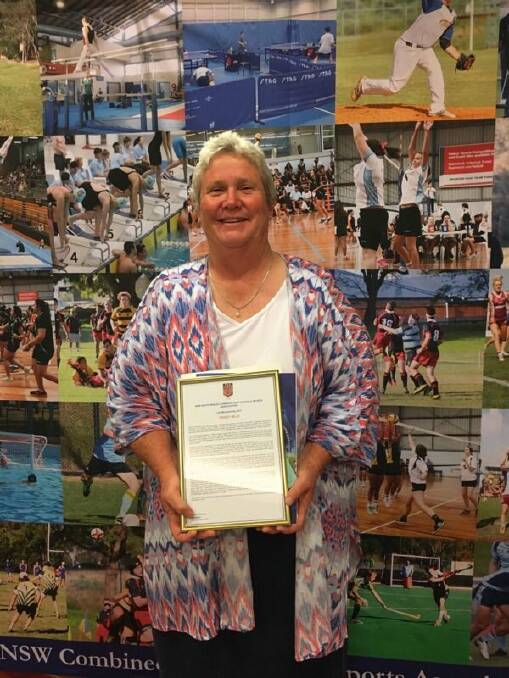 Tracey Bills, seen here with her life membership, has worked at Yass High for 30 years. Photo: Yass High School.