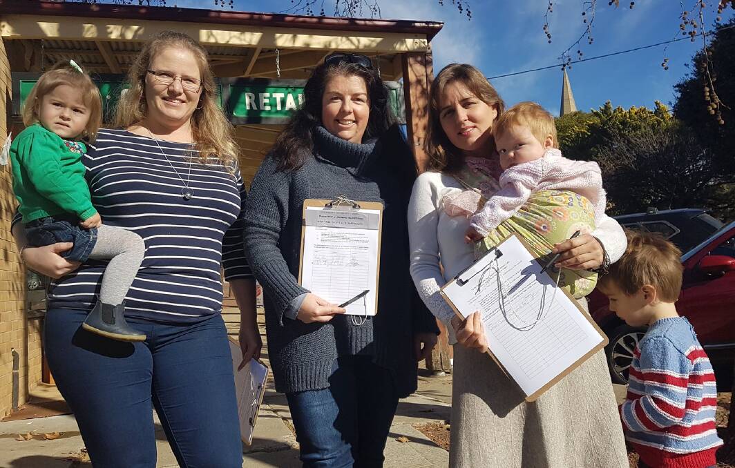 Concerned mothers: (from left) Lindsay Hollingsworth, Bec Duncan and Jasmin Jones with their children and petition. Photo: Zac Lowe