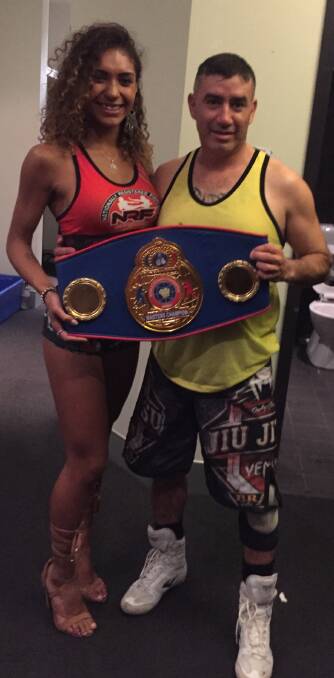 Title in hand: Spider and the ring girl for the night, Alicia, show off the former's Australian title following his victory over Paul Winston on June 8 at the Caloundra RSL. Photo: Supplied. 
