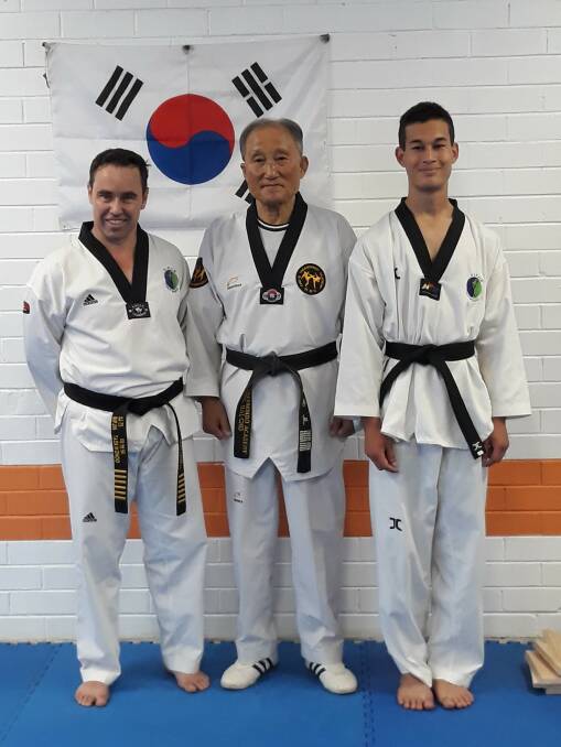 Masters: Craig Barrett (left) with his instructor, Grand Master Yong Dai Cho and Tanu Sudnit following his recent grading. Photo: Supplied.