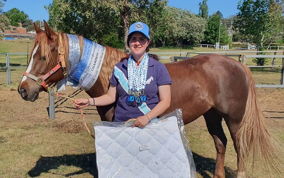 Proud winners: Darcie O'Sullivan and Bobby Dazzler, who came away with a veritable trove of medals and ribbons from the games. Photo: Supplied.