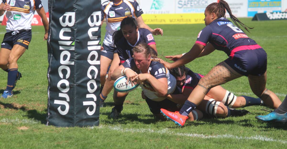 Almost there: Tayla Stanford crosses the line for her first of three tries against the Rebels on Sunday afternoon in Queanbeyan. Photo: Zac Lowe.