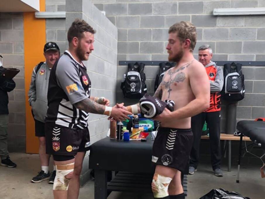 Brothers: Chris Rawlinson (left) presents Kaden Rawlinson with his first grade jersey ahead of his first grade debut last Saturday. Photo: Yass Magpies/Facebook.