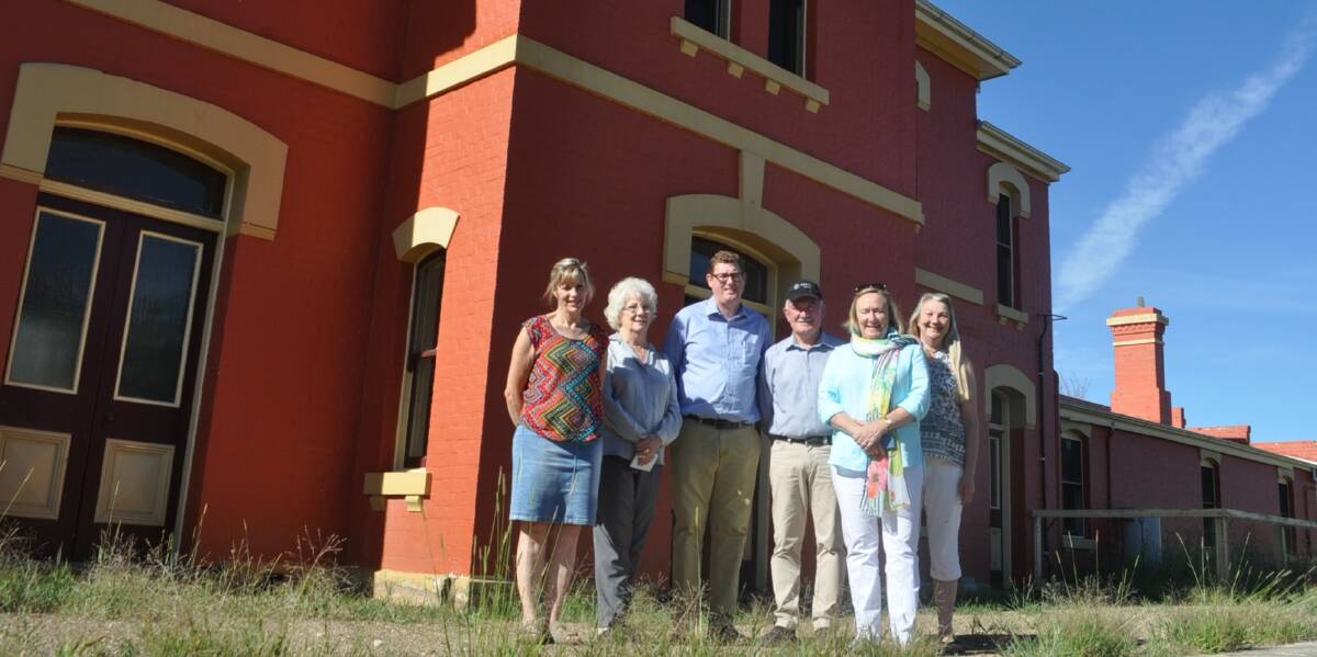 KEEPING IT GOING: Michael Irons (centre) from the Australian Rail Track Corporation with Bowning residents and Yass Valley mayor Rowena Abbey at the recently restored Bowning Railway Station. Photo: Toby Vue