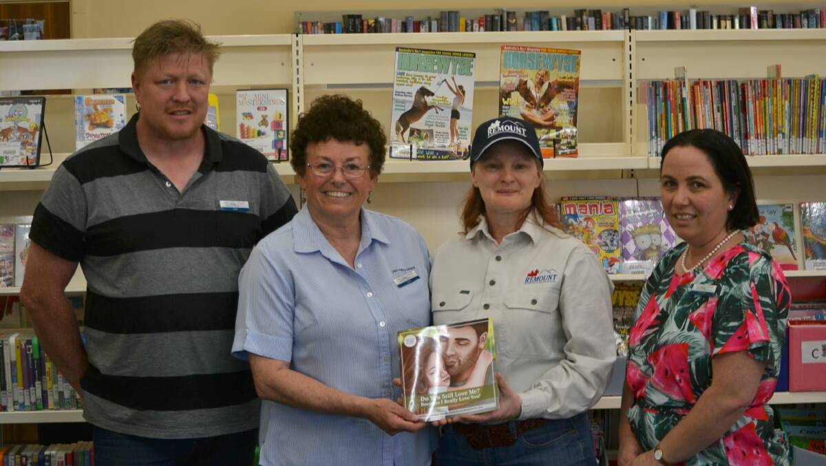 KIND DONATION: Jake Livingston, Jane McEvoy, Karen Williams, and Michelle Manderson welcome the donation from Remount at the library on Tuesday afternoon. Photo: Zac Lowe. 