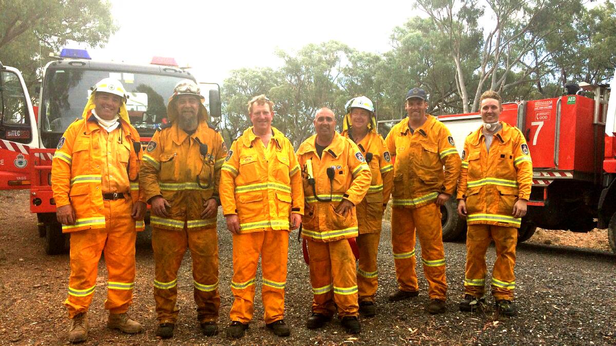 LOCAL LEGENDS: Firefighting brigades from Sutton and Yass River-Nanima posing for a photo after working hard to contain the fire near Sutton in February 2017 — the largest during the statutory bush fire period. Photo: Jessica Cole 
