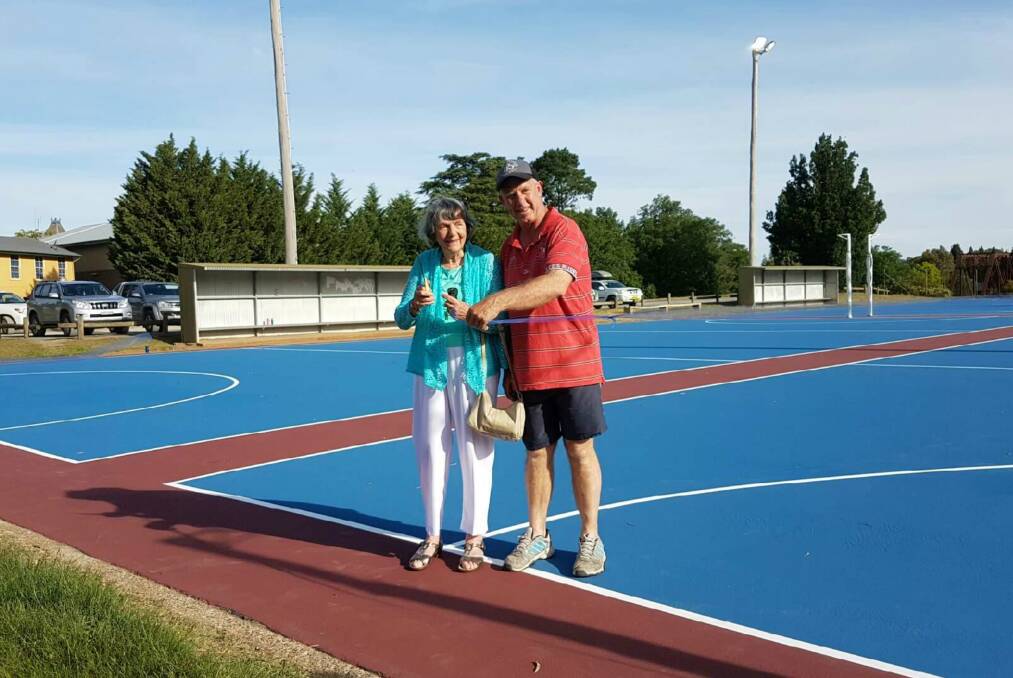 OFFICIALLY OPENED: Peg Keogh, wife of former sports council member Norm Keogh, and YNA executive member David Kemp cut the ribbon at O'Connor Park to opene the resurfaced courts in December 2016. Photo: Supplied