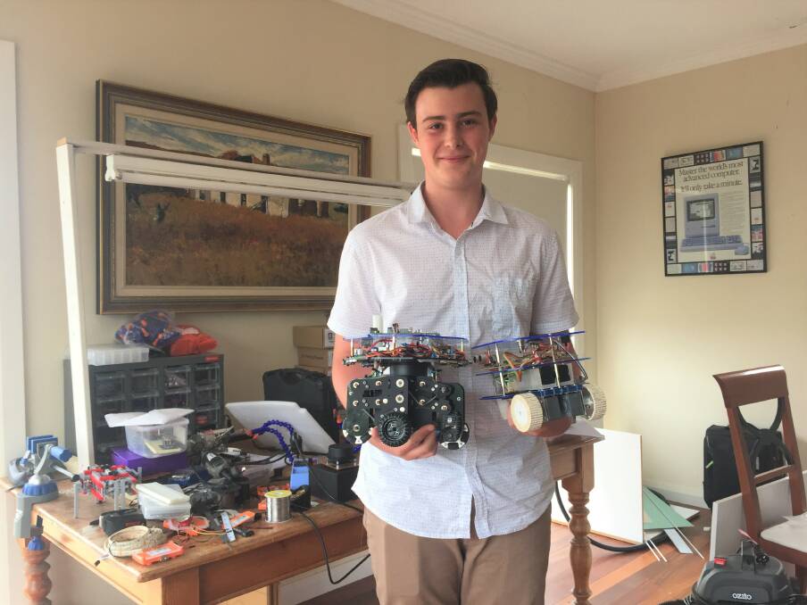 TECH WIZARD: Rory Wade at his home robotics laboratory with MASS and a 2015 model. Photo: Toby Vue