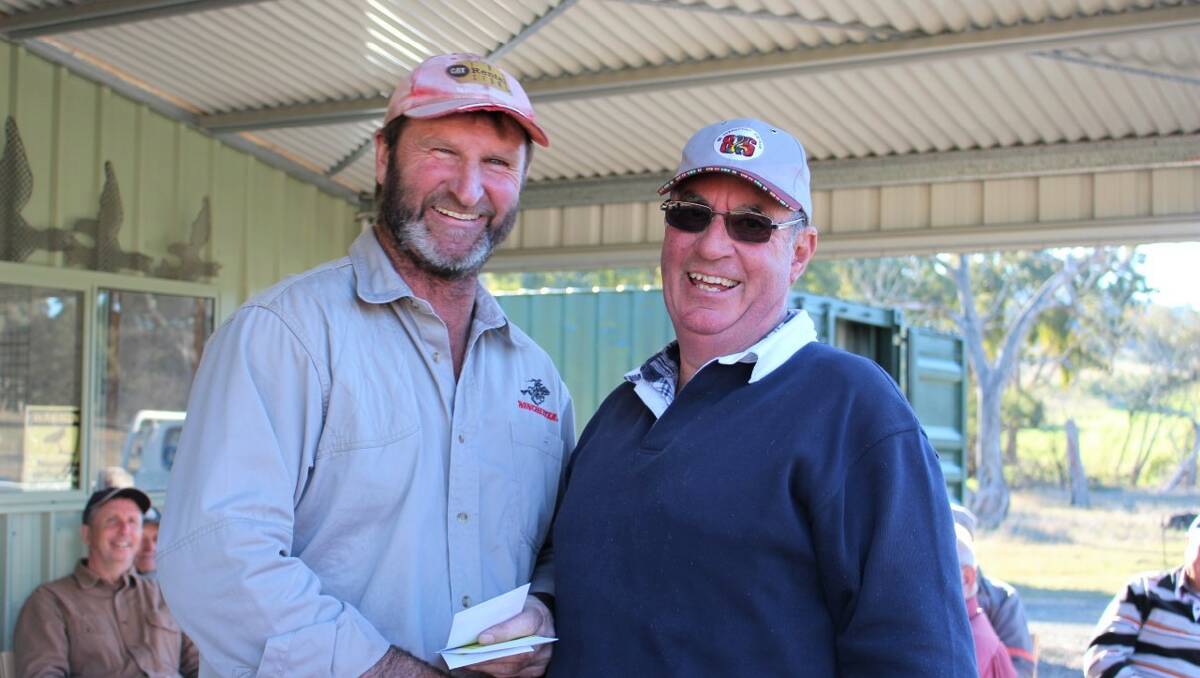 Phil Wales (president) awards Peter Southwell first in A grade for the 50 target point score. Photo: Yass Clay Target Club