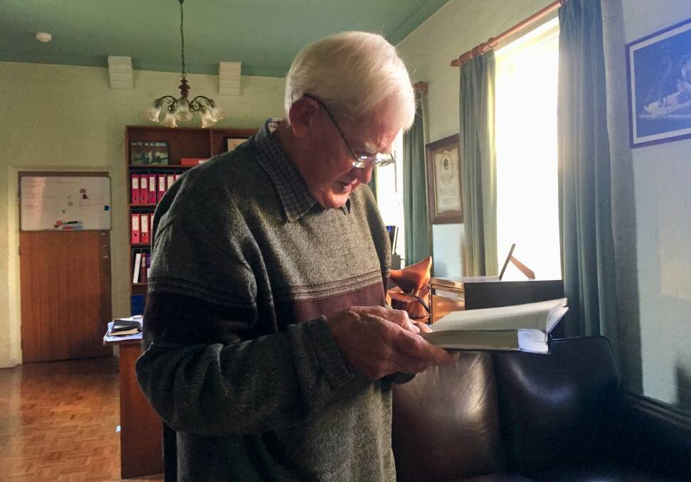REFLECTION: Brian O'Connor, who served 13 years as councillor, at his home office reading his diary that includes his numerous health tests and cancer surgery. Photo: Toby Vue.