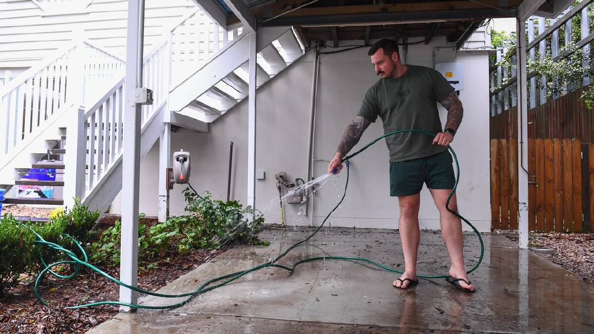 Flooding receded at Stephen Luke's Brisbane home but he's concerned about spills from a nearby dam. (Jono Searle/AAP PHOTOS) Flooding receded at Stephen Luke's Brisbane home but he's concerned about spills from a nearby dam. (Jono Searle/AAP PHOTOS)