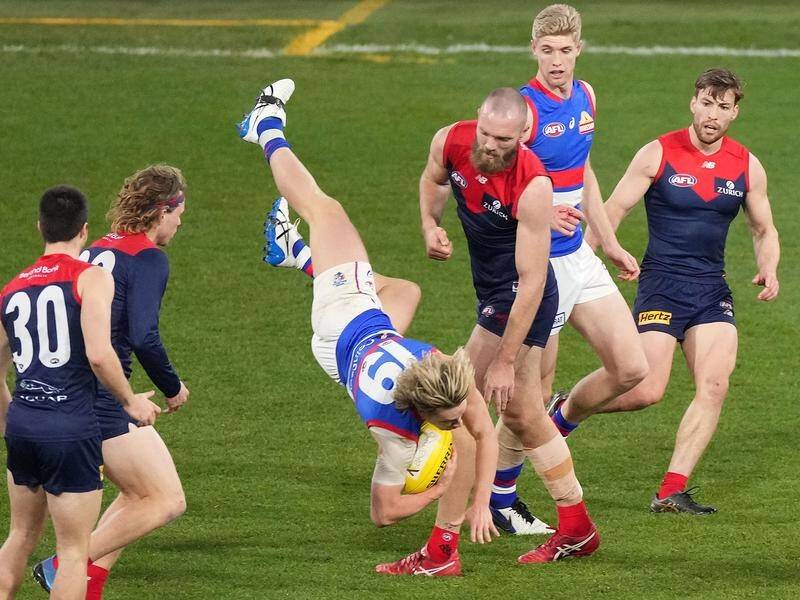 The AFL grand final between Melbourne and the Western Bulldogs is on for now despite a COVID case.