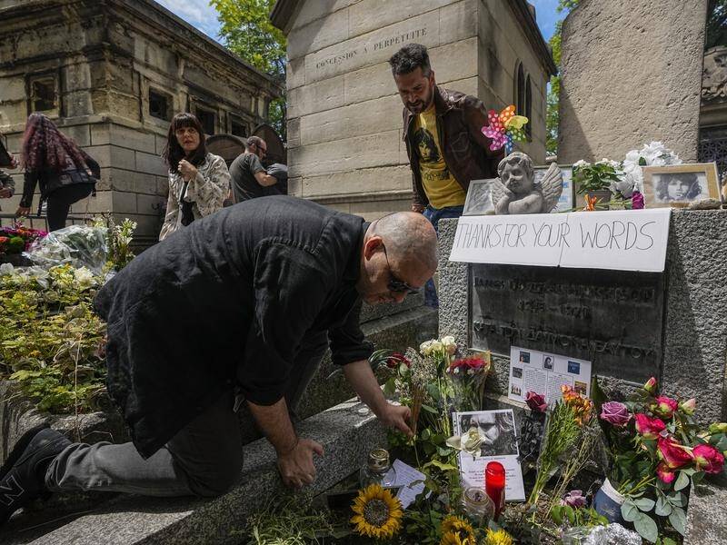 Fans gather at the tomb of rock singer Jim Morrison in Paris on the 50th anniversary of his death