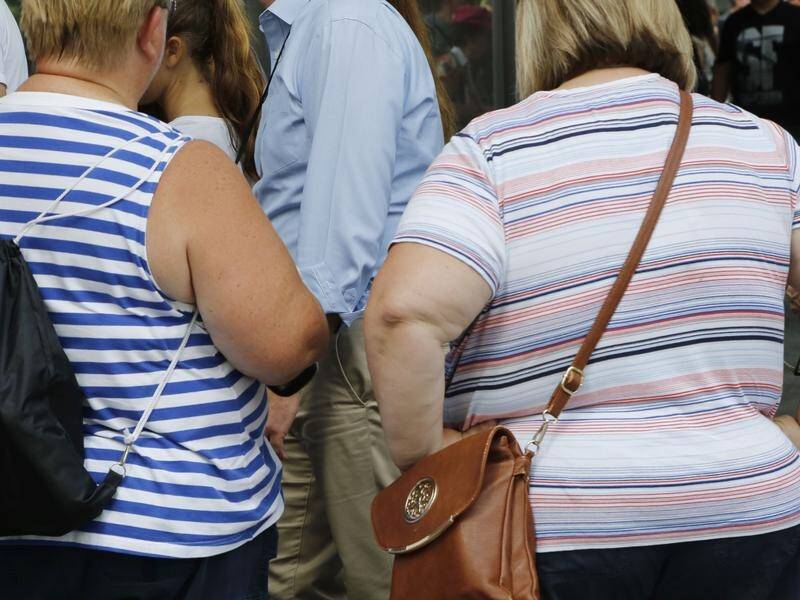 A study has found obesity in middle-aged women is linked to a greater long-term risk of dementia .