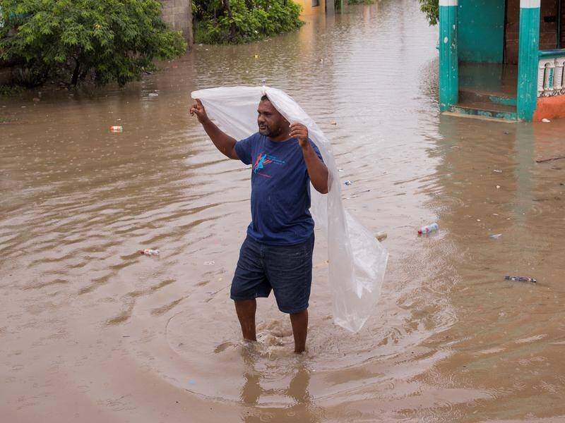 High winds downed power lines and rain brought flooding in the Dominican Republic.