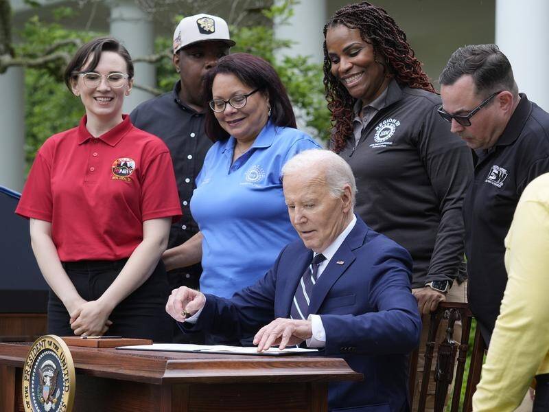 US President Joe Biden has signed a document at the White House imposing new tariffs. (AP PHOTO)