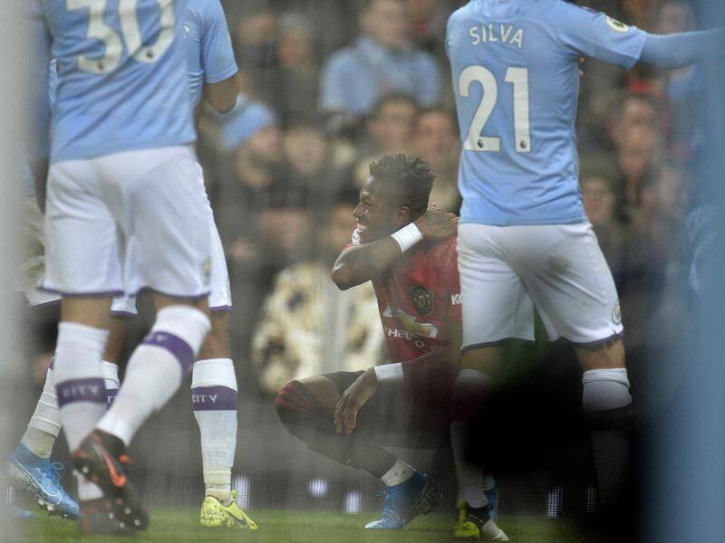 Manchester United's Fred (c) was hit by a projectile thrown from the crowd at the Etihad Stadium.