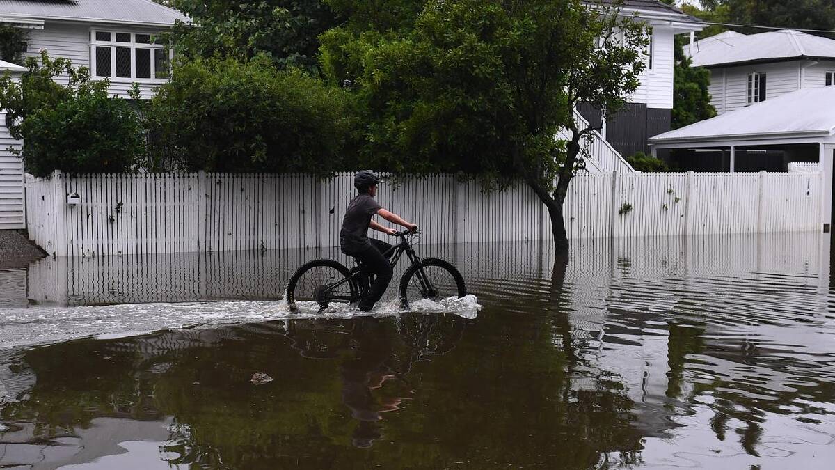 Streets in Newmarket, Brisbane, are flooded as the city deals with the aftermath of heavy rain. (Jono Searle/AAP PHOTOS) Streets in Newmarket, Brisbane, are flooded as the city deals with the aftermath of heavy rain. (Jono Searle/AAP PHOTOS)