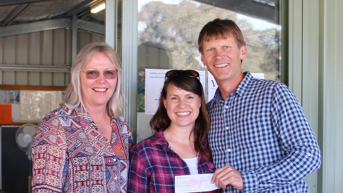 Trina Watchorn of the Yass Clay Target Club presents a cheque for $700 to Yass Vine Community FoodCare’s Sharleen and Kurt Bailey.
