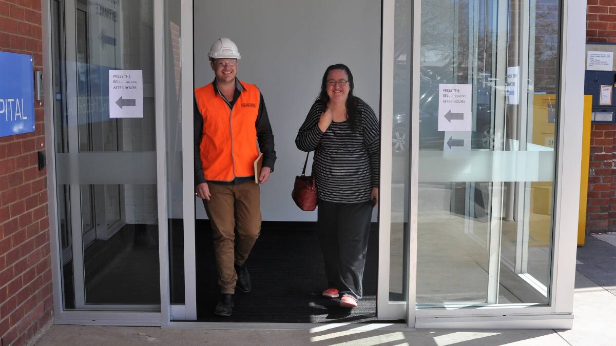 STEPS FORWARD: Richard Crookes Constructions project engineer Trystan Warn and Yass resident Deb Glassford use the new air lock entrance at Yass Hospital. Photo: Hannah Sparks