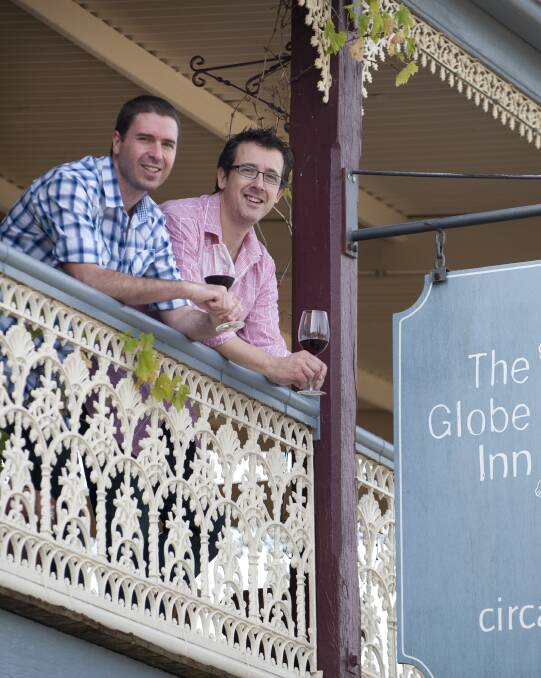 Greg Miller and David Small look over the veranda of their Georgian guesthouse in Yass. Photo: supplied