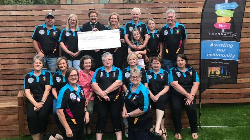 HELPING HAND: Commonwealth Bank Yass branch manager Ryan Cassidy hands over the $500 cheque to Yass Valley SPIN Foundation volunteers. Photo: supplied