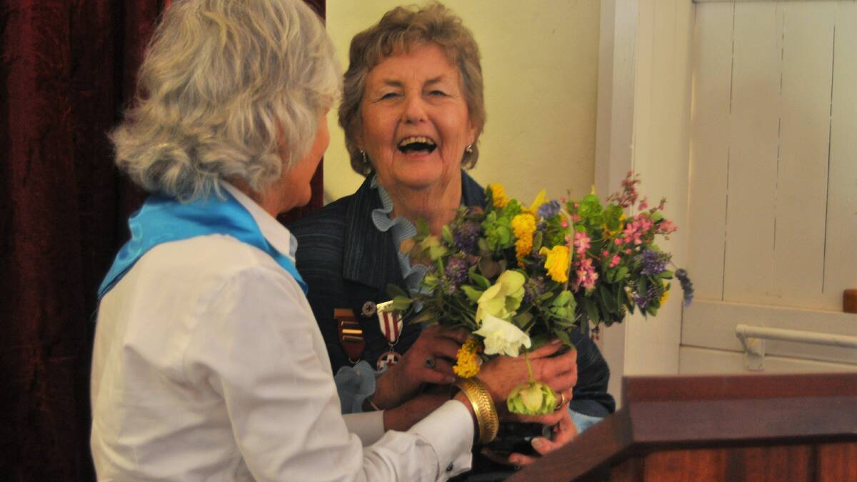 SPECIAL THANKS: Bookham Berremangra Red Cross president Noeleen Hazell is given flowers for her service at the 80th anniversary celebration.