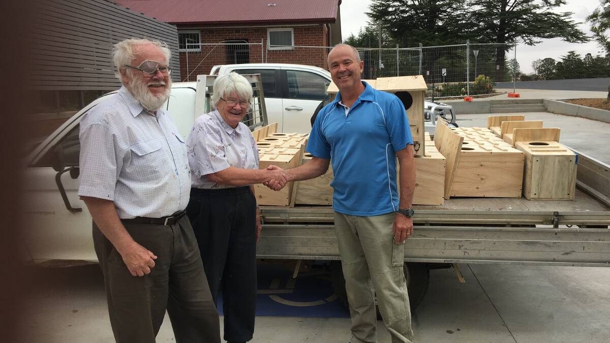 Kevin and Jane Baker thank Yass High School's construction teacher, Mr Ralph Hansen, for the possum boxes. Photo: supplied