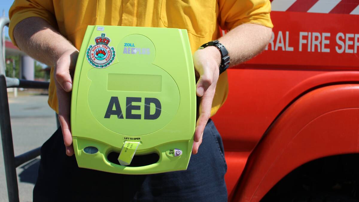 READY FOR AN EMERGENCY: NSW RFS operational officer - Southern Tablelands Zone, Lachlan Gilchrist holds an AED stored on every RFS vehicle. Photo: Hannah Sparks