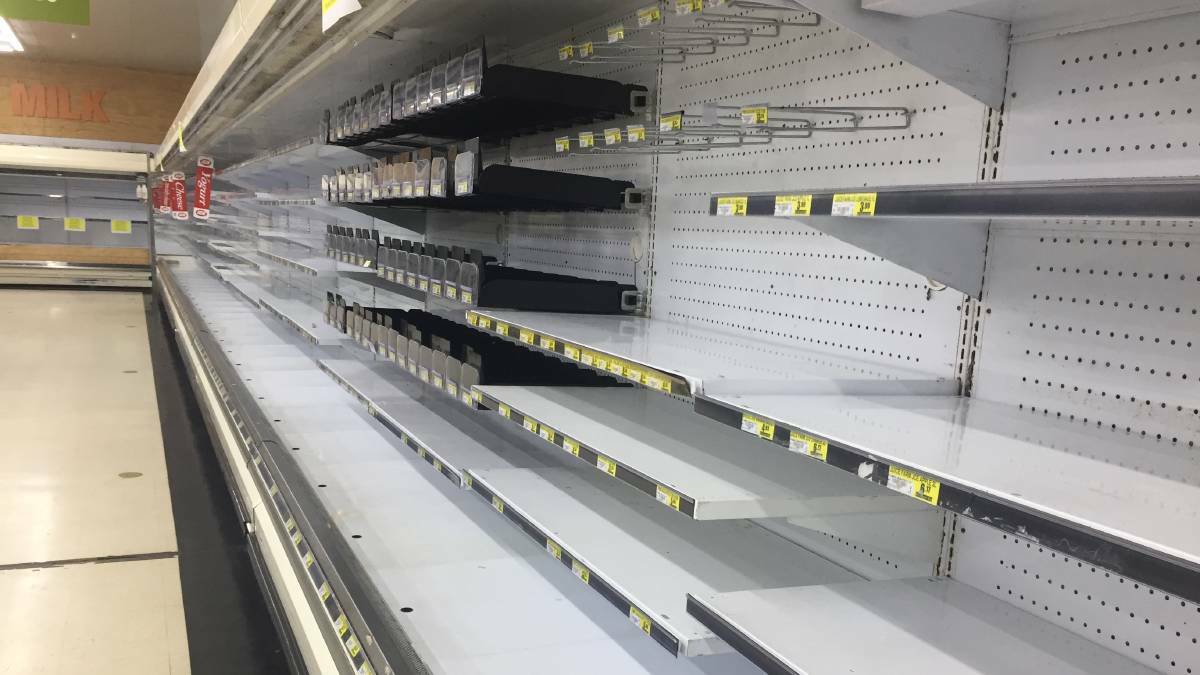 An empty dairy aisle at Yass IGA.