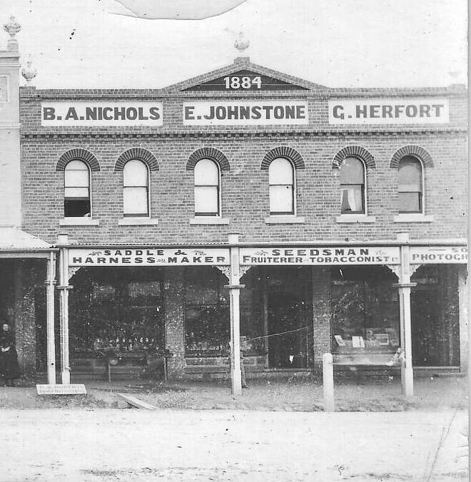 Outside of the Herfort building, showing the original occupants. Picture by Yass & District Historical Society Collection. Circa 1880s.