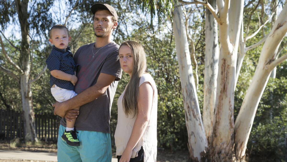 Chris Reynolds (left) and Cassandra Brown-Crane (right) with their two-year-old son Alijah Reynolds the day after he was allegedly left in a bus at a childcare centre. Photo: Sitthixay Ditthavong