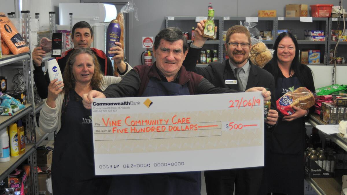 FoodCare Volunteers: Kevin Mitchell (food coordinator), Ruth Sneesby (co-manager), Ryan Cassidy (CommBank Yass branch manager), Brian Figura (maintenance) and Deb Tizzoni (manager) accept the cheque for $500. Photo: Hannah Sparks