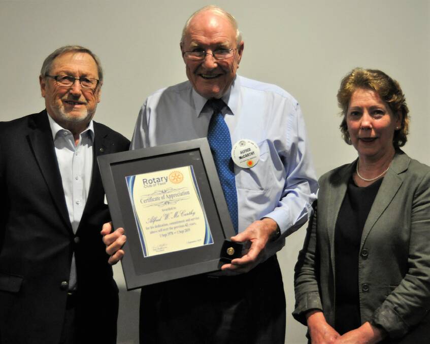 Alfred McCarthy is awarded for 40 years of service with the Rotary Club of Yass by member John Brassil (left) and president Tony Hopkins (right). Photo: Hannah Sparks