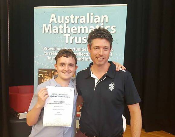 MATHS-WHIZZ: Mitchell is pictured with St Francis Xavier College's maths coordinator Damien Nemeth with his certificate for Best in State, ACT in Year 8 at the 2018 Australian Mathematics Competition on Tuesday. Photo: supplied
