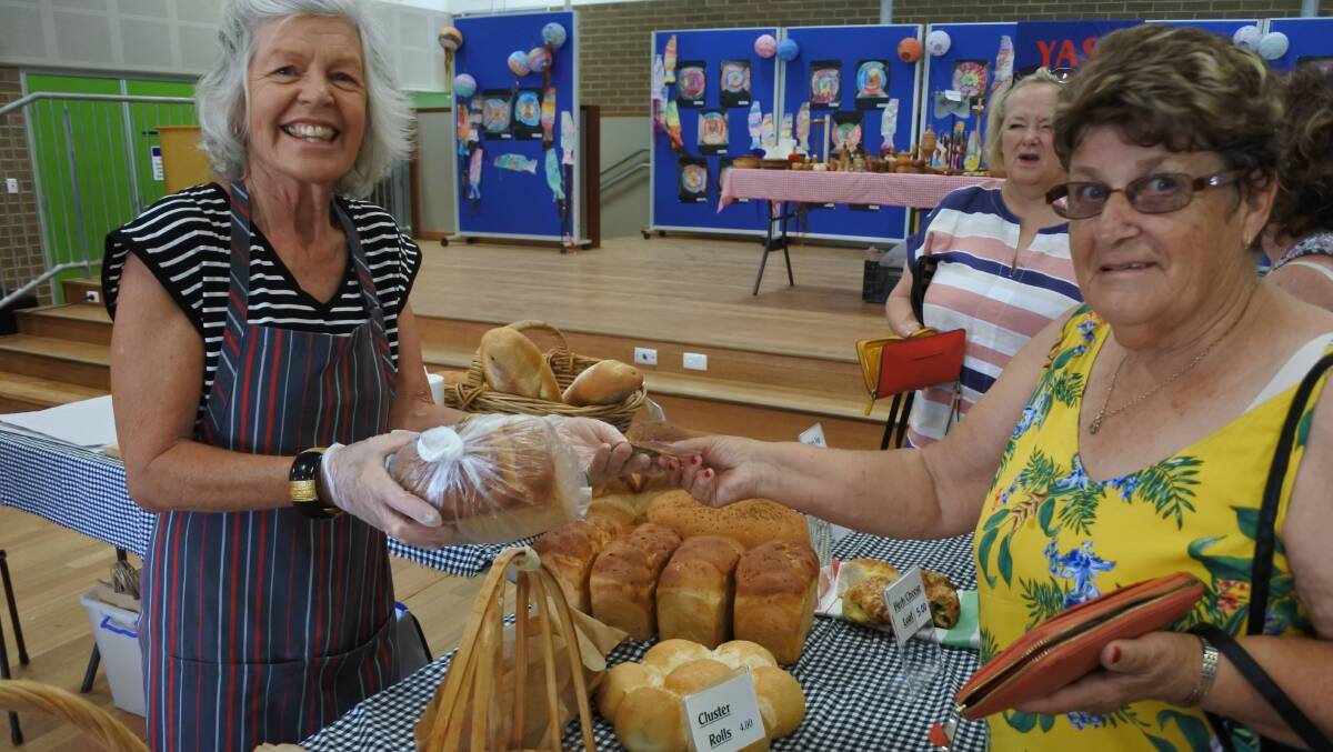 A DONE DEAL: Bimbi Turner sells bread to June Maher at the Yass Community Markets. Photo: Hannah Sparks