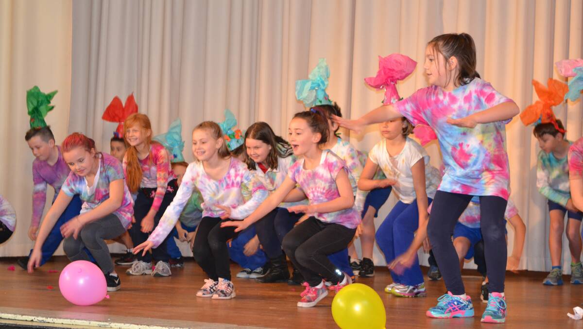 Students from the Binit Binit Learning Community perform on stage.