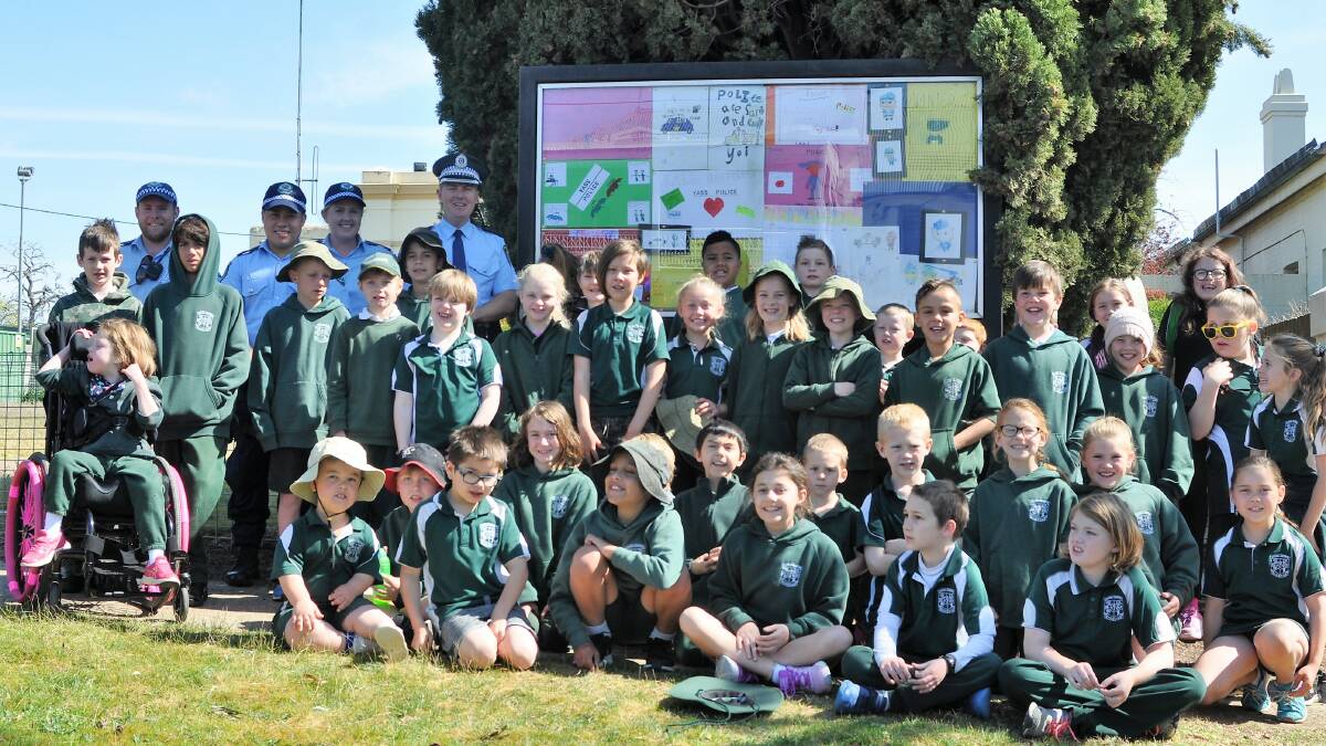 COPS ARE TOPS: Berinba Public School students display their artwork in the noticeboard at Yass Police Station. Photo: Hannah Sparks