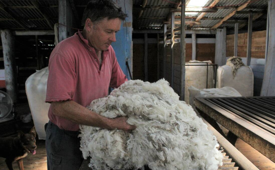 Ed Storey checks the wool recently shorn at Werong to prepare for a low rainfall in autumn.