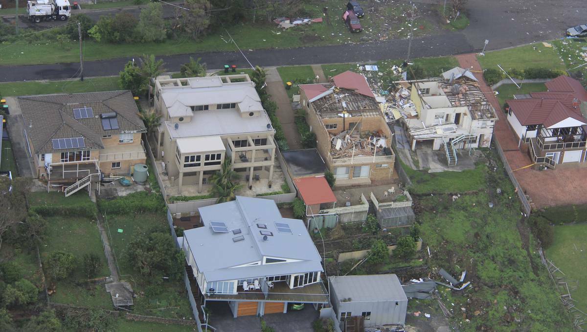 Experts survey the damage at Kiama, in the NSW Illawarra. Photos: COLIN DOUCH, DAVE TEASE