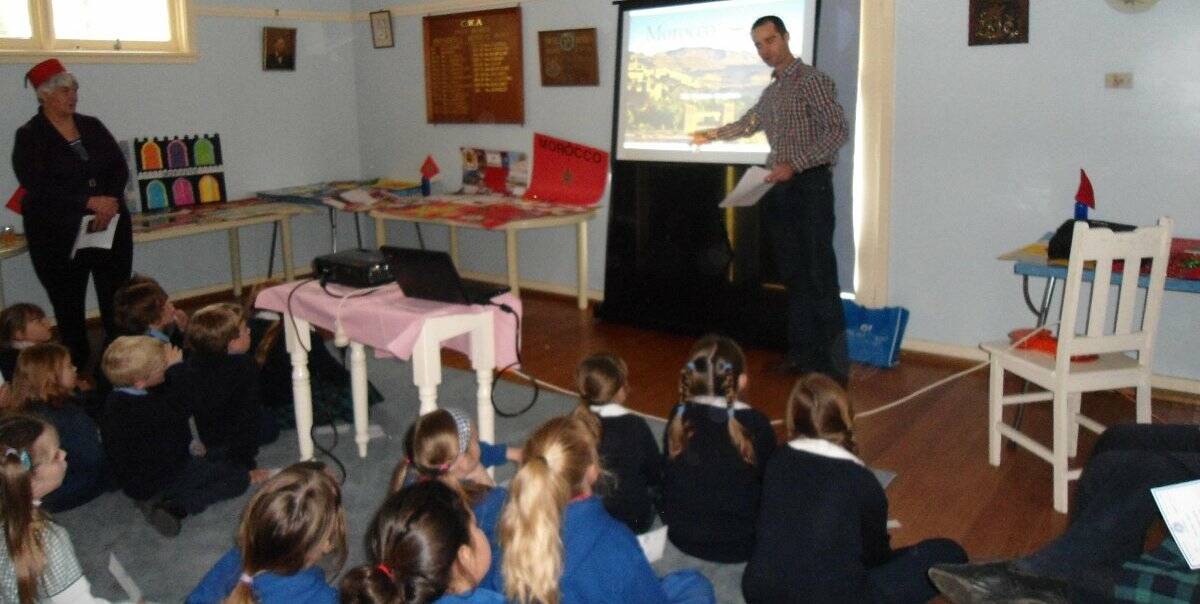 Teacher Denis Carol presents a talk on Morocco to school students as part of the Yass CWA Country of Study Poster Competition.