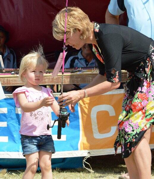 Youngster Hayley Reardon is presented with a new fishing rod by Burrinjuck MP Katrina Hodgkinson.