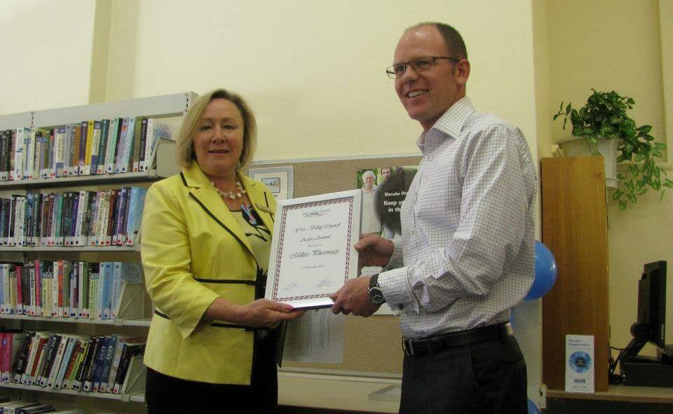 Mayor Rowena Abbey presents an Access Award to Peter Miller of Miller's Pharmacy.