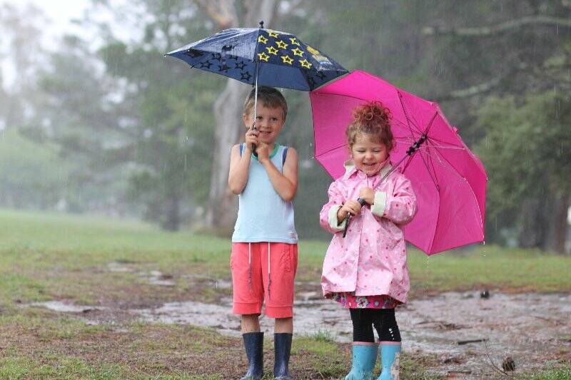 On the last day of summer Elijah and Leila Kay enjoyed splashing in the pouring rain. Photo: Tiffany Grange.