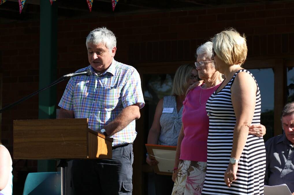 Deputy mayor Geoff Frost presents Dorothy Lock and her family with Tom Lock's community service award.